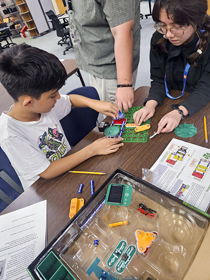 Middle school student working on electronic tech